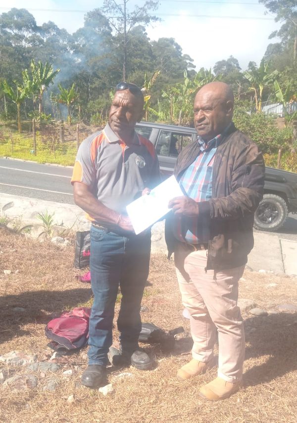 Presenting the Community Curriculum handbook after the seven week rollout. Mankui (SDA), Chuave, Simbu. July 2026.
